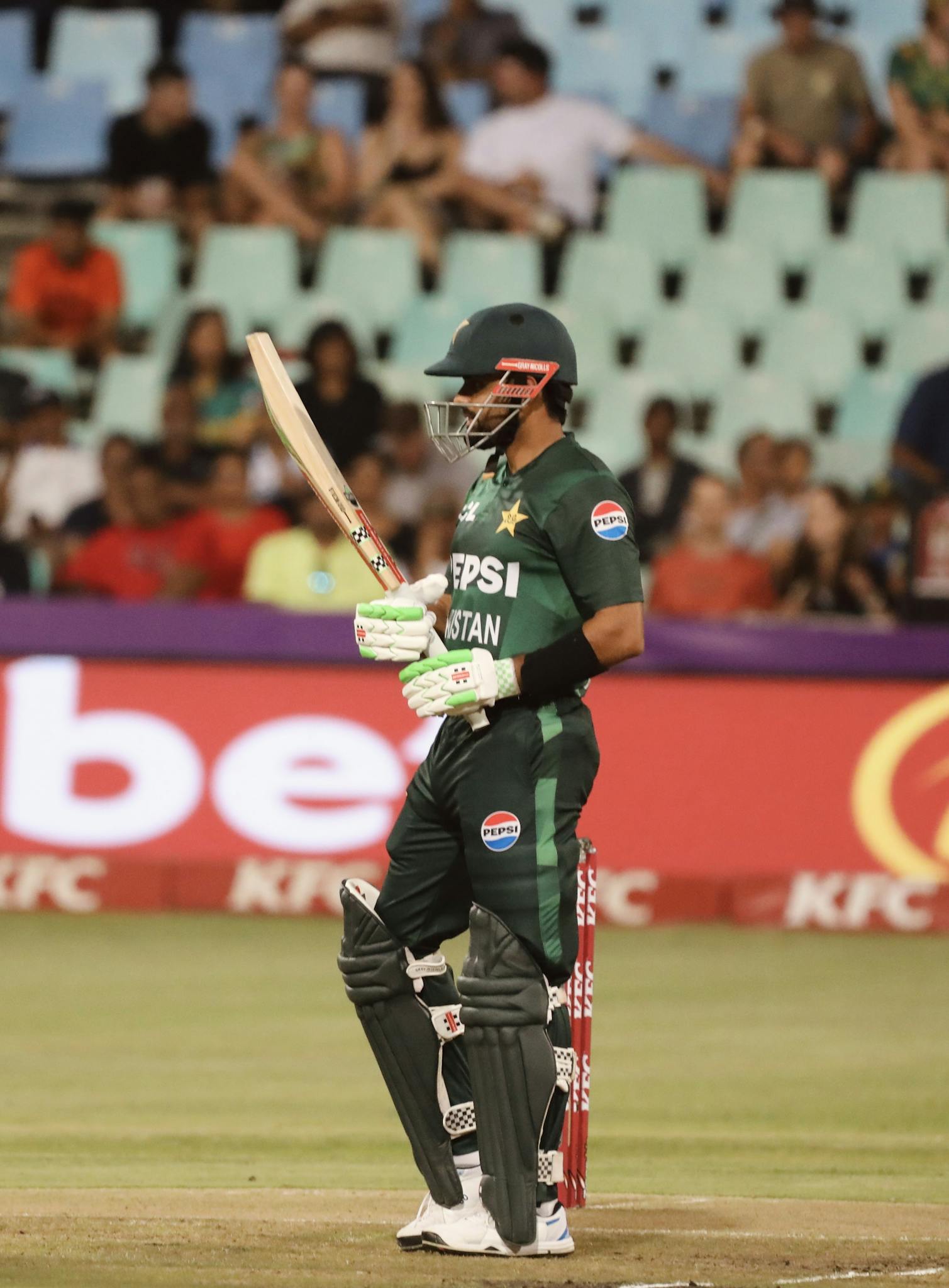 Cricket player from Pakistan in full gear during a competitive match.